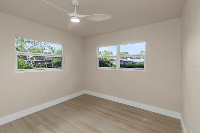 empty room featuring baseboards, light wood-style floors, and a ceiling fan