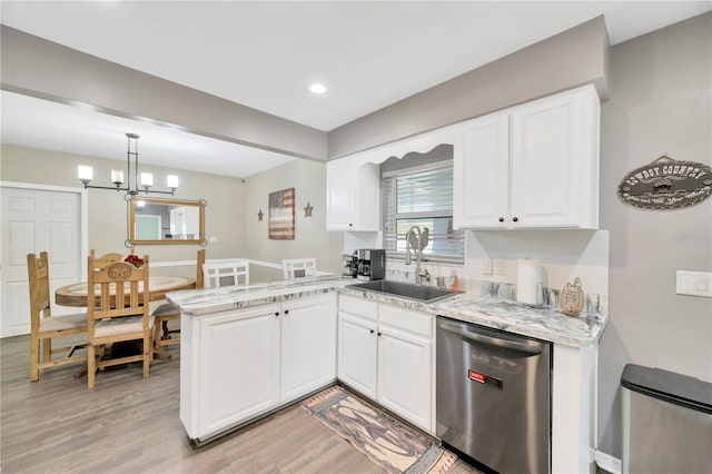 607 Carolyn Dr, Brandon, FL 33510 - kitchen with a sink, light wood-style floors, dishwasher, white cabinetry, and a peninsula