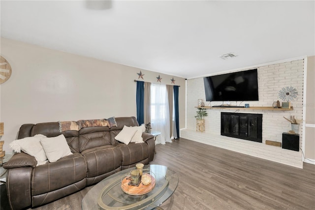 607 Carolyn Dr, Brandon, FL 33510 - living room featuring a brick fireplace, visible vents, and wood finished floors