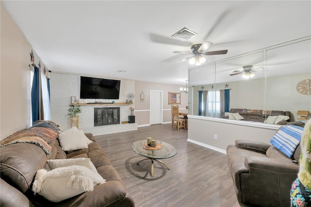 607 Carolyn Dr, Brandon, FL 33510 - living room with ceiling fan, visible vents, a fireplace, wood finished floors, and baseboards