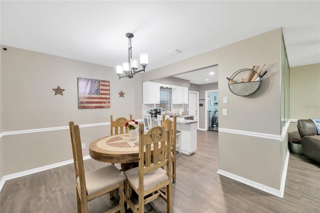 607 Carolyn Dr, Brandon, FL 33510 - dining area with visible vents, baseboards, a notable chandelier, and light wood-type flooring
