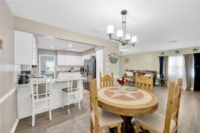 607 Carolyn Dr, Brandon, FL 33510 - dining space with recessed lighting, visible vents, an inviting chandelier, and light wood-type flooring