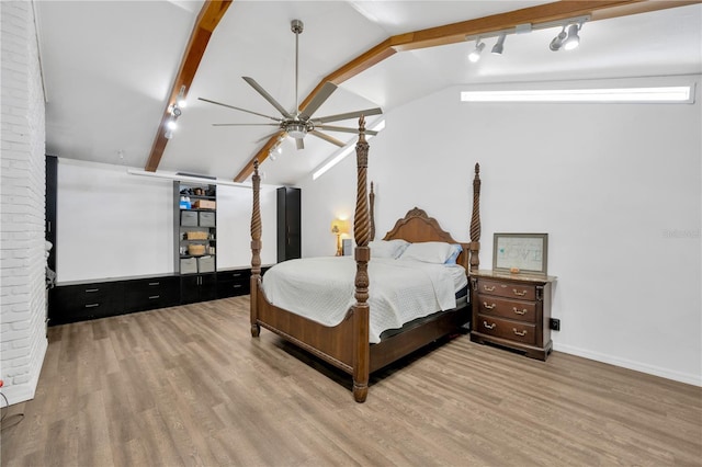 607 Carolyn Dr, Brandon, FL 33510 - bedroom with track lighting, lofted ceiling with beams, baseboards, and wood finished floors