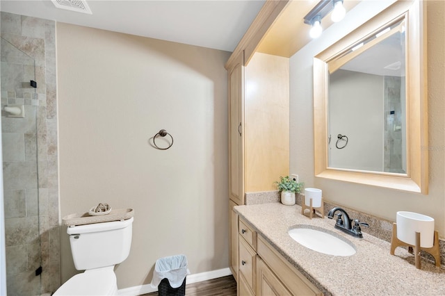 607 Carolyn Dr, Brandon, FL 33510 - bathroom featuring visible vents, a tile shower, vanity, baseboards, and toilet