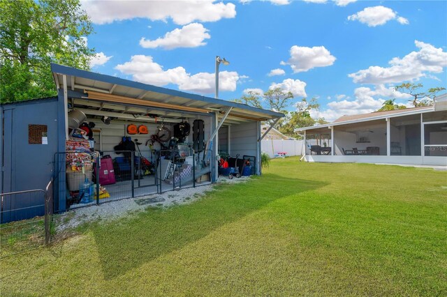 607 Carolyn Dr, Brandon, FL 33510 - back of property with a lawn, fence, and a sunroom