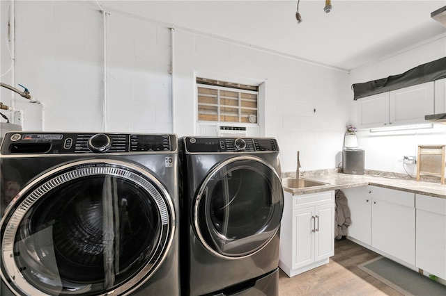 607 Carolyn Dr, Brandon, FL 33510 - laundry room featuring cabinet space, separate washer and dryer, a sink, and light wood-style flooring