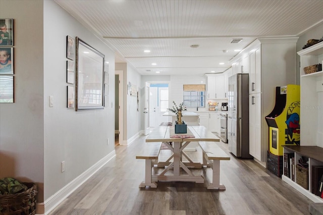 dining area with recessed lighting, baseboards, visible vents, and light wood-type flooring