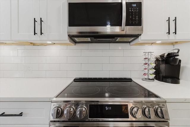 details featuring light countertops, appliances with stainless steel finishes, backsplash, and white cabinetry