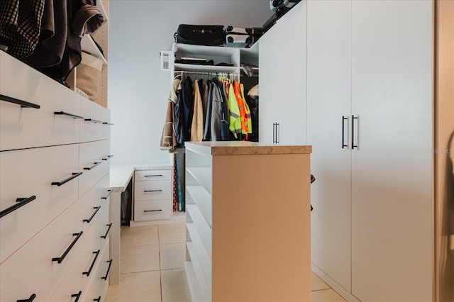 spacious closet with light tile patterned floors