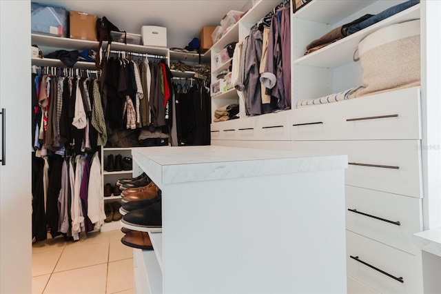 walk in closet with light tile patterned flooring