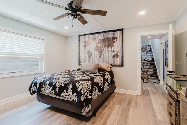bedroom with light wood-style floors, recessed lighting, and baseboards