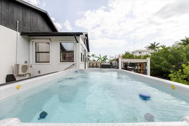 view of swimming pool with ac unit