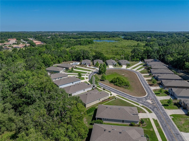 drone / aerial view featuring a forest view and a residential view