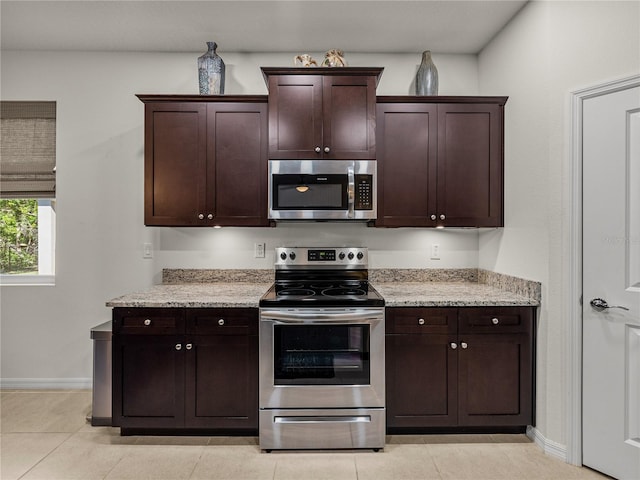 kitchen with baseboards, stainless steel appliances, and dark brown cabinets