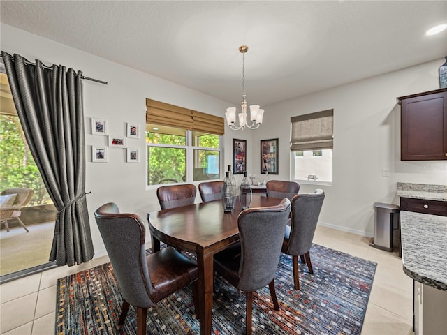 dining room with light tile patterned floors, a wealth of natural light, and a chandelier