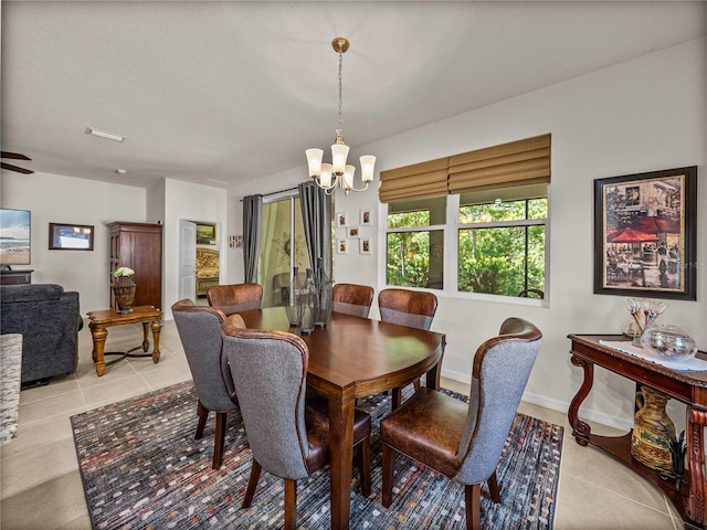 dining room featuring a notable chandelier, baseboards, and light tile patterned floors