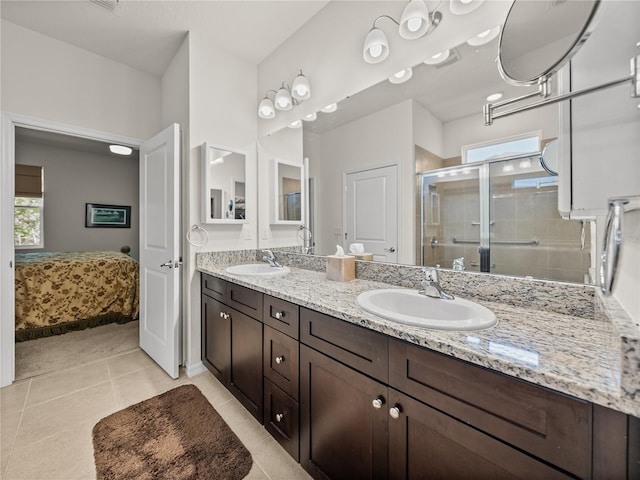 bathroom featuring a wealth of natural light, a stall shower, and a sink