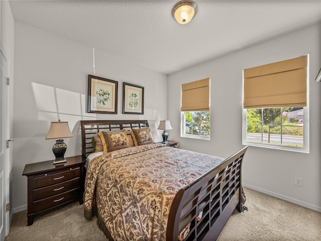 carpeted bedroom featuring baseboards