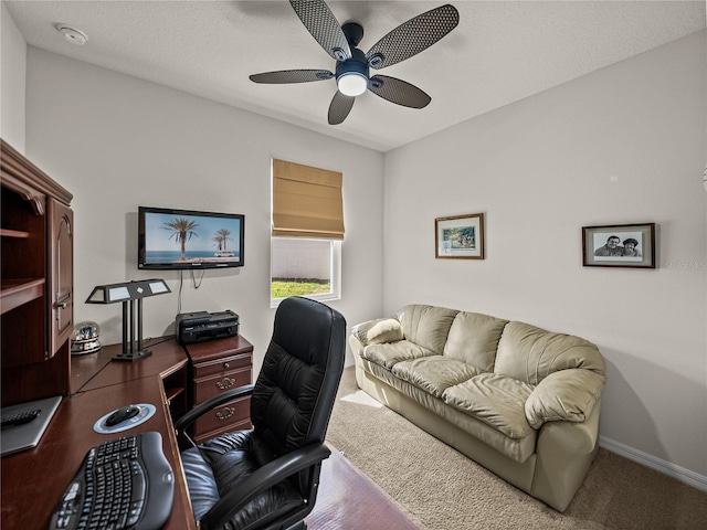 home office with baseboards and a ceiling fan