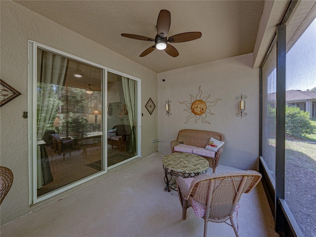 sunroom / solarium featuring a ceiling fan