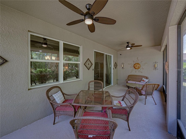 sunroom with outdoor dining area and ceiling fan