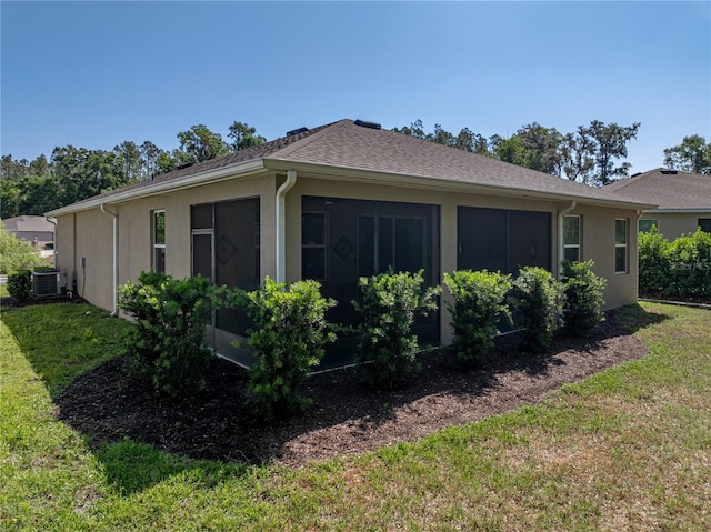 view of property exterior featuring a yard, central air condition unit, stucco siding, and a shingled roof