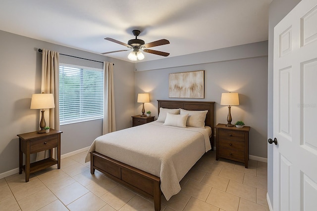 bedroom featuring baseboards, a ceiling fan, and light tile patterned floors