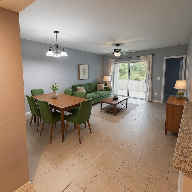 dining area with baseboards, light tile patterned floors, and ceiling fan with notable chandelier