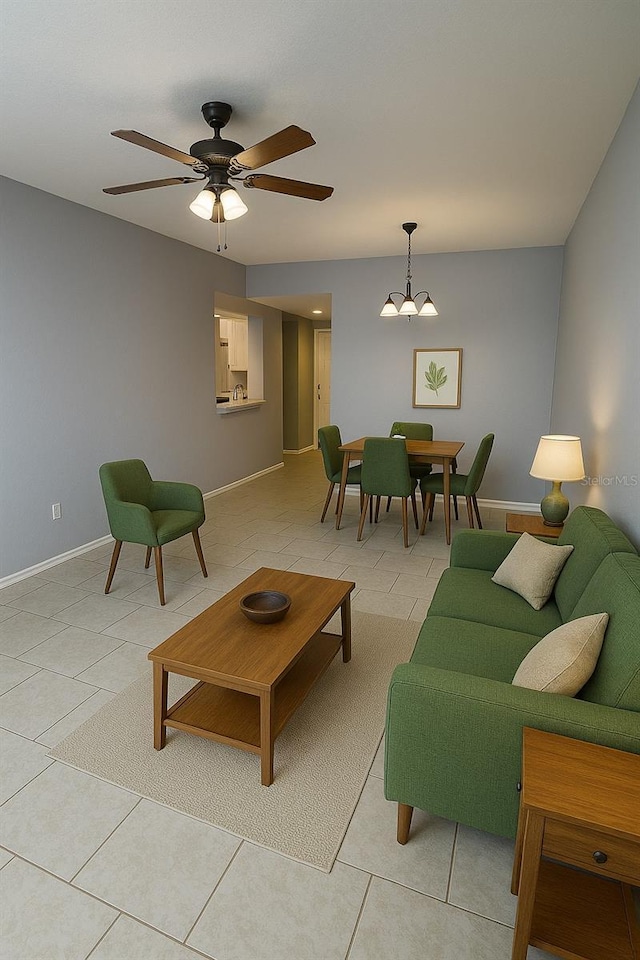 living room featuring baseboards, ceiling fan with notable chandelier, and light tile patterned floors