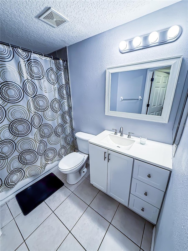 bathroom featuring visible vents, vanity, curtained shower, toilet, and a textured ceiling