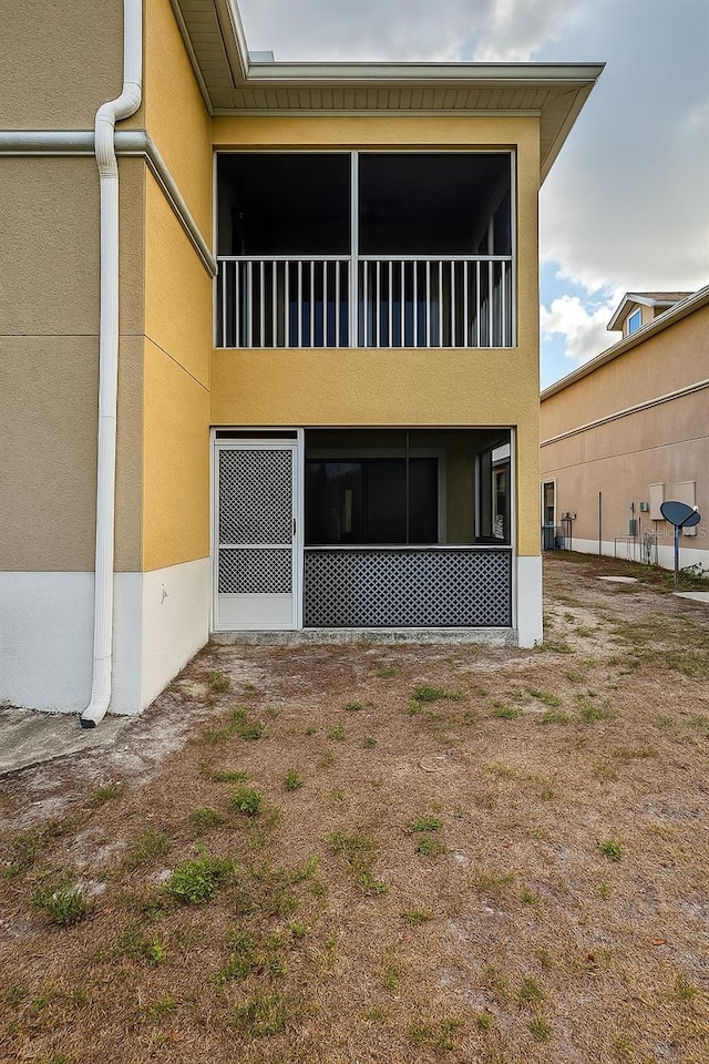back of house featuring stucco siding