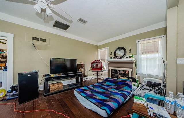 41 W Boyer St, Tarpon Springs, FL 34689 - living room with a ceiling fan, wood finished floors, a fireplace, a textured ceiling, and ornamental molding