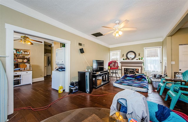 41 W Boyer St, Tarpon Springs, FL 34689 - living room with a ceiling fan, estacked washer and dryer, wood-type flooring, crown molding, and a textured ceiling