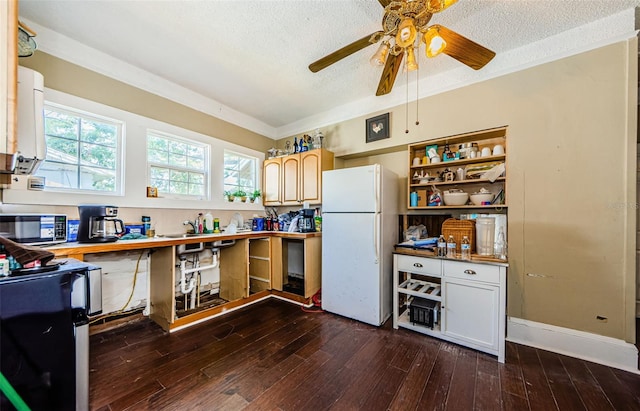 41 W Boyer St, Tarpon Springs, FL 34689 - kitchen with freestanding refrigerator, a textured ceiling, dark wood finished floors, ceiling fan, and fridge