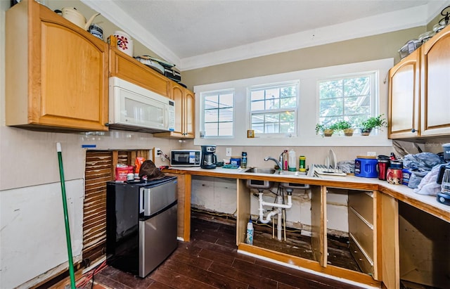 41 W Boyer St, Tarpon Springs, FL 34689 - kitchen with white microwave, dark wood-style flooring, healthy amount of natural light, freestanding refrigerator, and ornamental molding