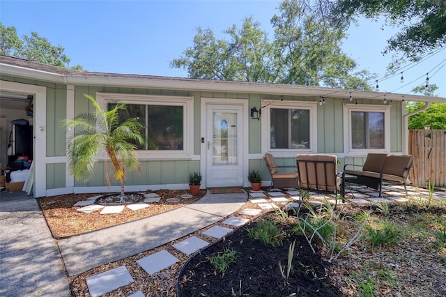 506 Summerwood Ct, Tarpon Springs, FL 34689 - doorway to property featuring board and batten siding and a patio