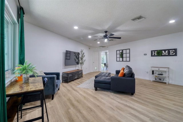 506 Summerwood Ct, Tarpon Springs, FL 34689 - living area with a ceiling fan, light wood-style floors, recessed lighting, a textured ceiling, and baseboards
