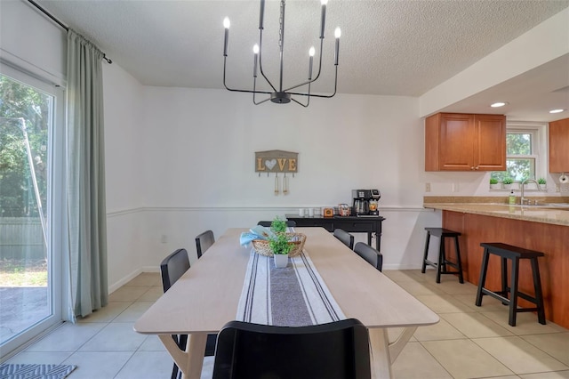 506 Summerwood Ct, Tarpon Springs, FL 34689 - dining area with a chandelier, light tile patterned floors, plenty of natural light, and a textured ceiling