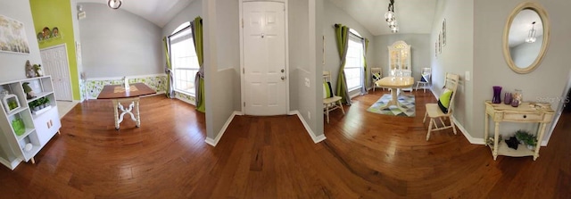 entrance foyer with baseboards, lofted ceiling, a wealth of natural light, and wood finished floors