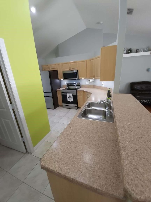 kitchen featuring light tile patterned flooring, appliances with stainless steel finishes, a sink, light brown cabinets, and visible vents