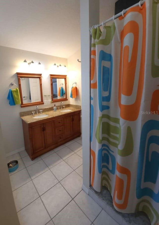 bathroom featuring a shower with curtain, tile patterned floors, and a sink