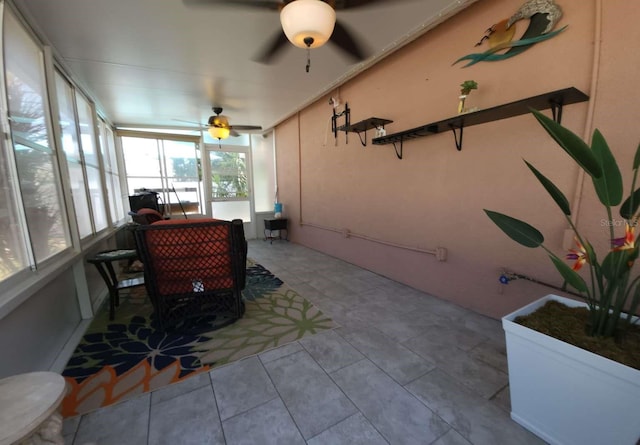 sunroom featuring ceiling fan