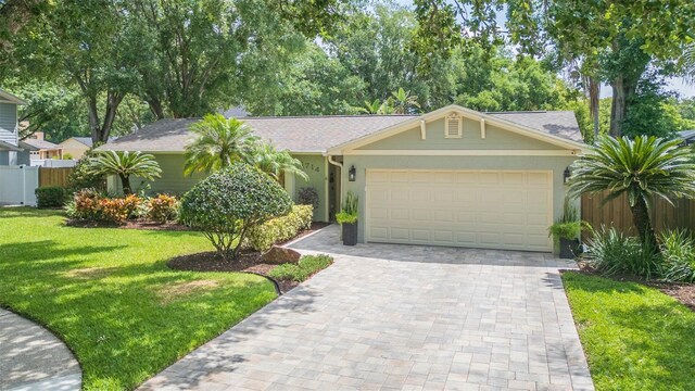 3714 Village Estates Pl, Tampa, FL 33618 - ranch-style home featuring fence, a garage, stucco siding, a front lawn, and decorative driveway