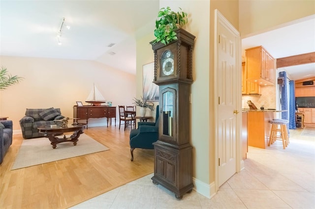 3714 Village Estates Pl, Tampa, FL 33618 - hall featuring rail lighting, lofted ceiling, and light tile patterned floors