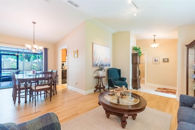 3714 Village Estates Pl, Tampa, FL 33618 - living area featuring an inviting chandelier, track lighting, light wood-type flooring, visible vents, and lofted ceiling
