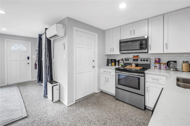 kitchen featuring light countertops, a wall mounted AC, stainless steel appliances, and recessed lighting
