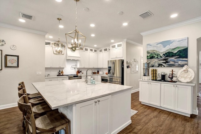 kitchen featuring visible vents, baseboards, dark wood finished floors, and stainless steel appliances