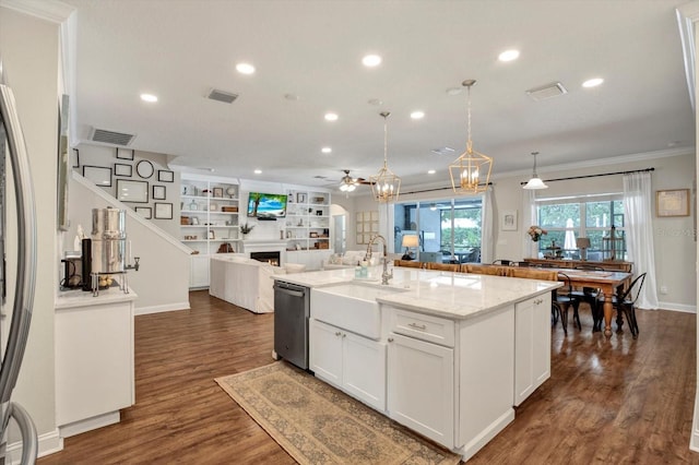 kitchen with a lit fireplace, a sink, ceiling fan with notable chandelier, open floor plan, and stainless steel appliances