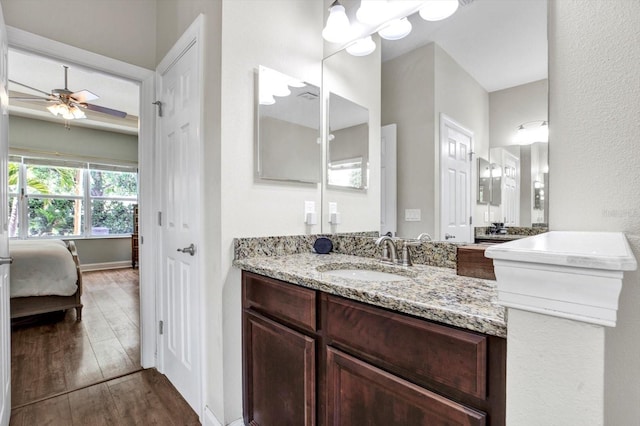 bathroom featuring vanity, a ceiling fan, connected bathroom, and wood finished floors