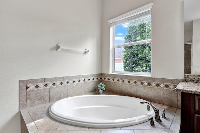 bathroom with vanity, plenty of natural light, and a garden tub